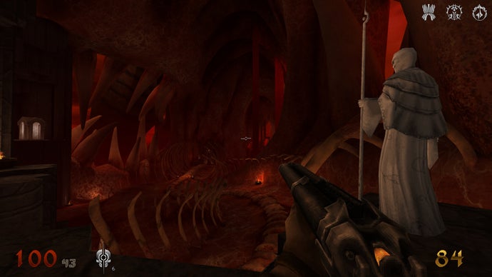 A screenshot of Wrath: Aeon of Ruin, depicting the player inside a large hub area made of flesh and bone, standing beside a white, bald figure holding a staff.