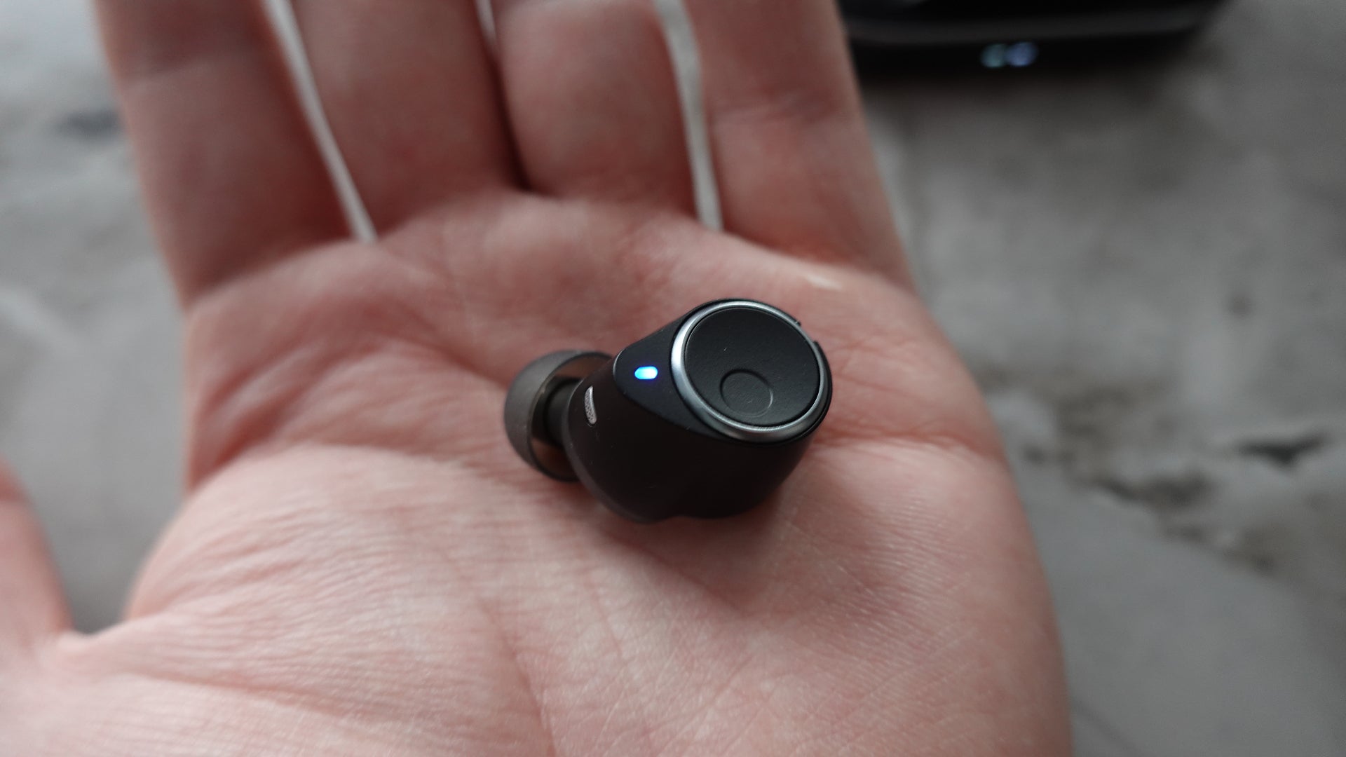 Cambridge Audio Melomania M100 earbud in hand
