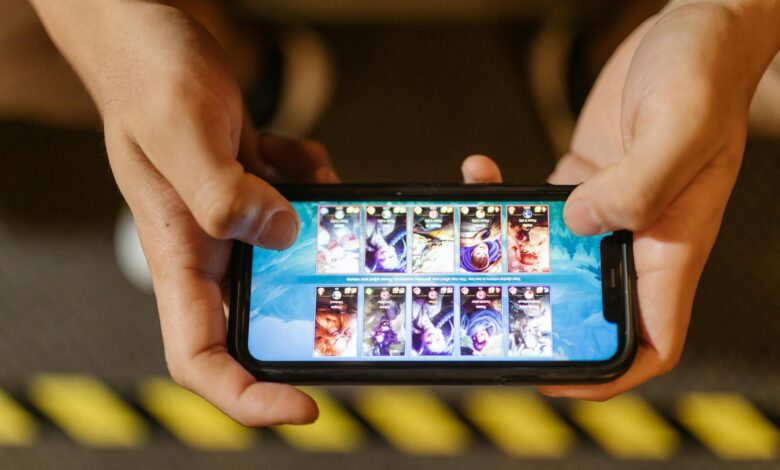 Person playing mobile game on smartphone with focused concentration