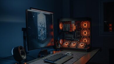 Gaming PC setup with multiple monitors displaying graphics settings menus