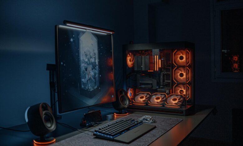 Gaming PC setup with multiple monitors displaying graphics settings menus