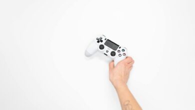 Modern gaming controller next to console showing indie game interface