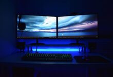 Modern gaming PC setup with monitor displaying performance metrics and RGB lighting