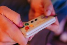 Close-up of retro gaming controller on dark surface, representing classic Nintendo gaming experience