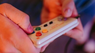 Close-up of retro gaming controller on dark surface, representing classic Nintendo gaming experience