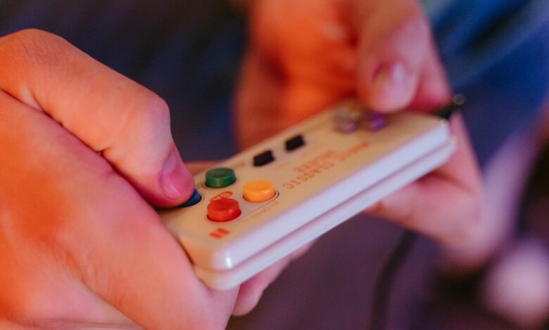 Close-up of retro gaming controller on dark surface, representing classic Nintendo gaming experience