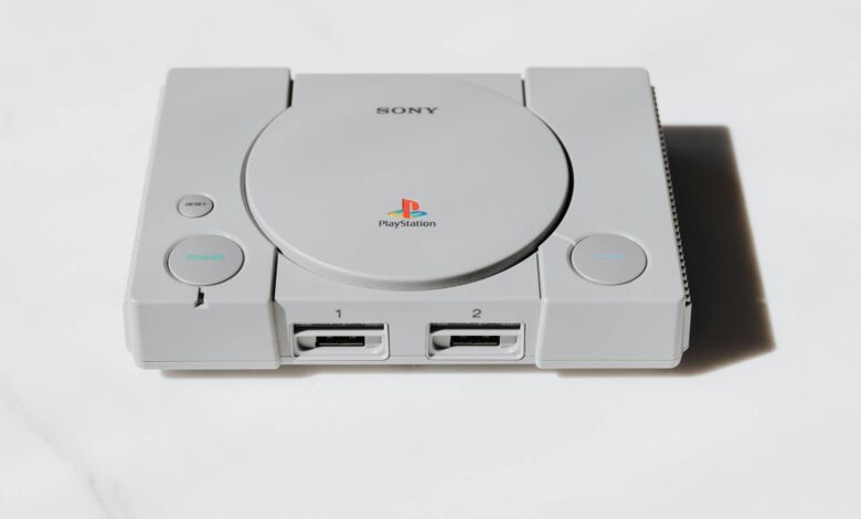 Modern gaming console with wireless controller on entertainment center