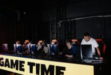 Professional esports tournament setup with multiple gaming stations and large screens