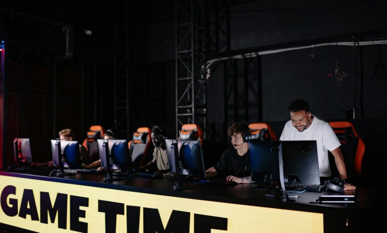 Professional esports tournament setup with multiple gaming stations and large screens