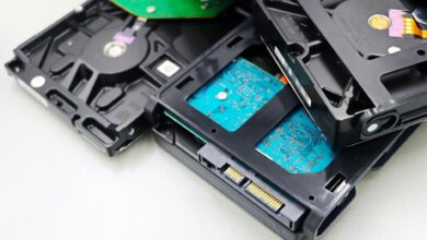 Various computer storage drives and components arranged on a desk