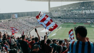 Empty soccer stadium with green pitch and seating areas