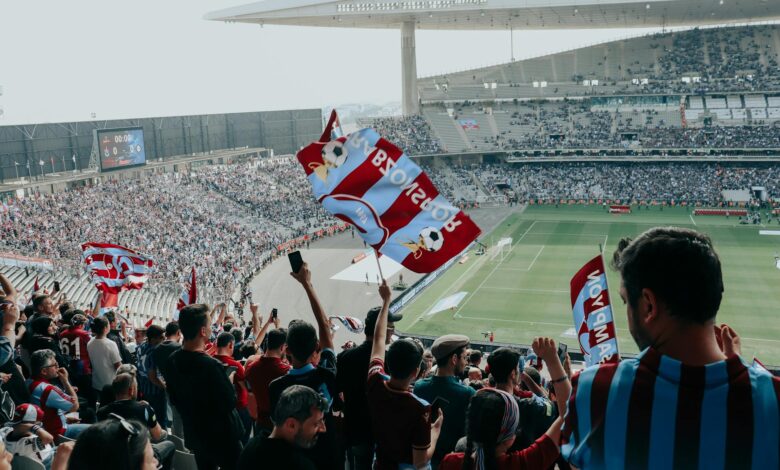 Empty soccer stadium with green pitch and seating areas