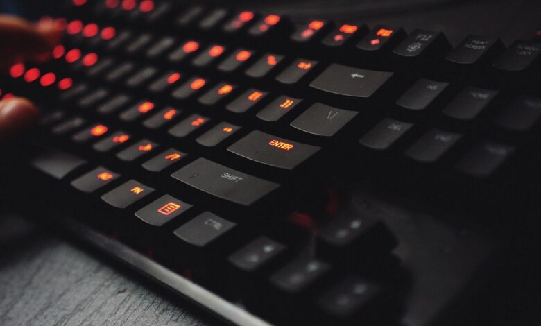 Close-up of mechanical gaming keyboard with RGB backlighting on desk