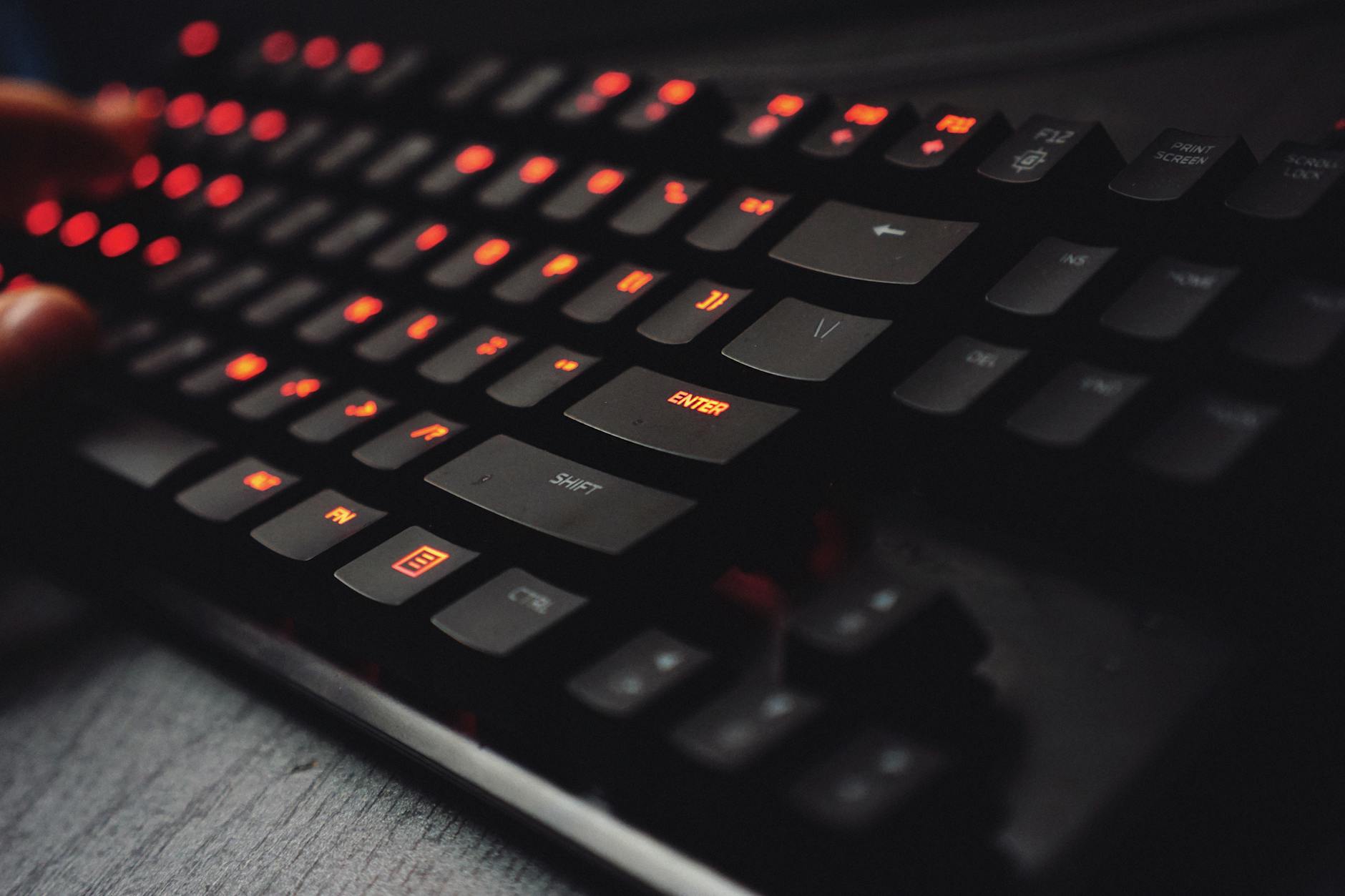 Close-up of mechanical gaming keyboard with RGB backlighting on desk