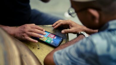 Person holding smartphone displaying mobile gaming interface