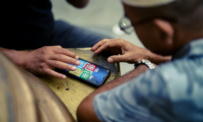 Person holding smartphone displaying mobile gaming interface