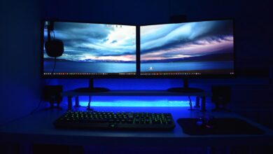 Professional gaming monitor setup with RGB lighting on desk