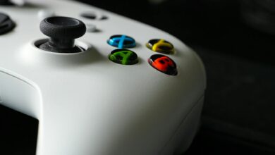 Modern gaming controller next to console representing subscription gaming services