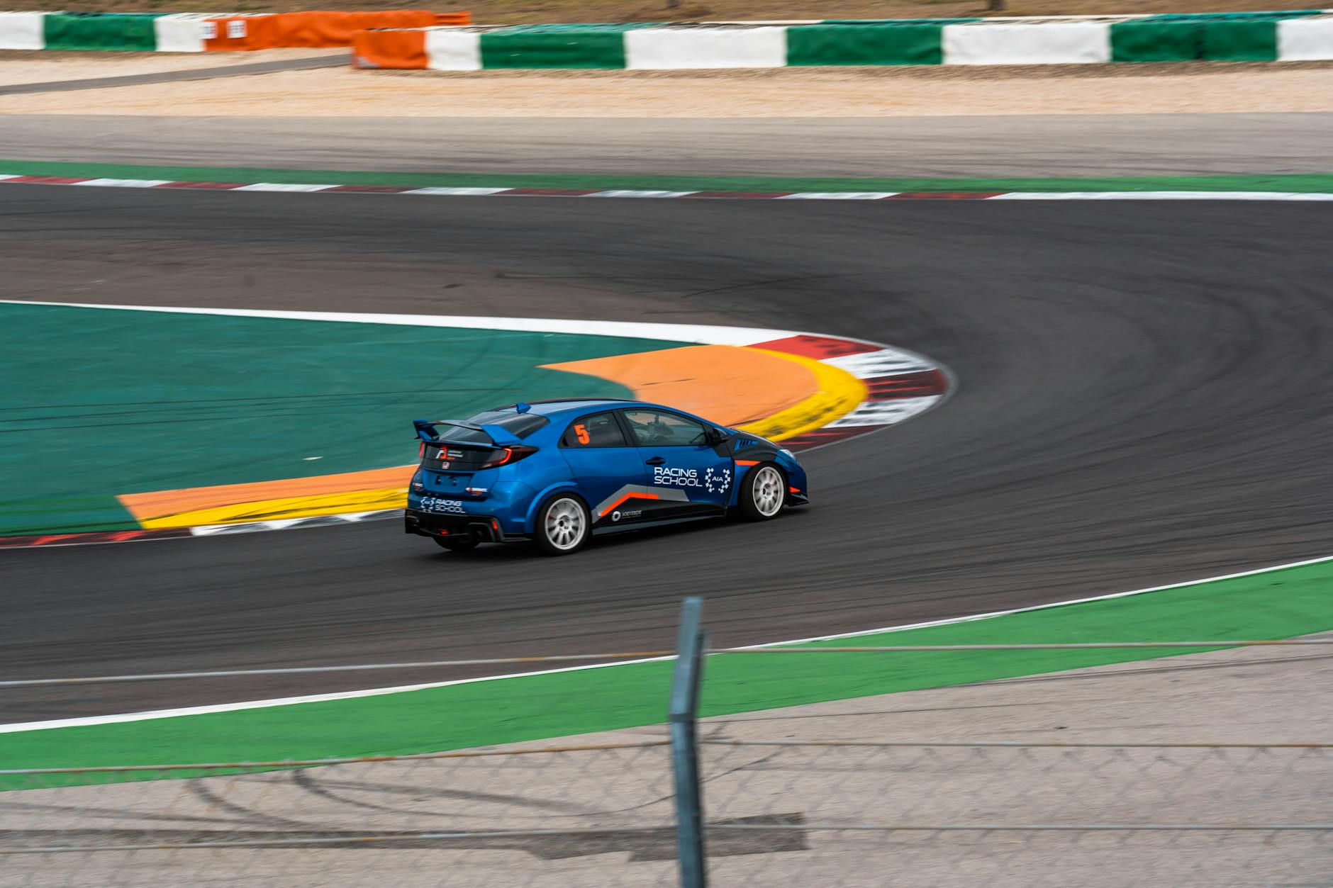Professional racing car on circuit track showcasing high-speed motorsport action