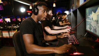 Professional esports tournament arena with gaming setups and stage lighting