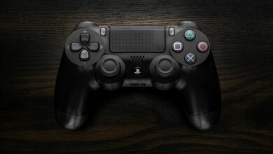 Close-up of a gaming controller being held, showing the precision input buttons used in competitive play