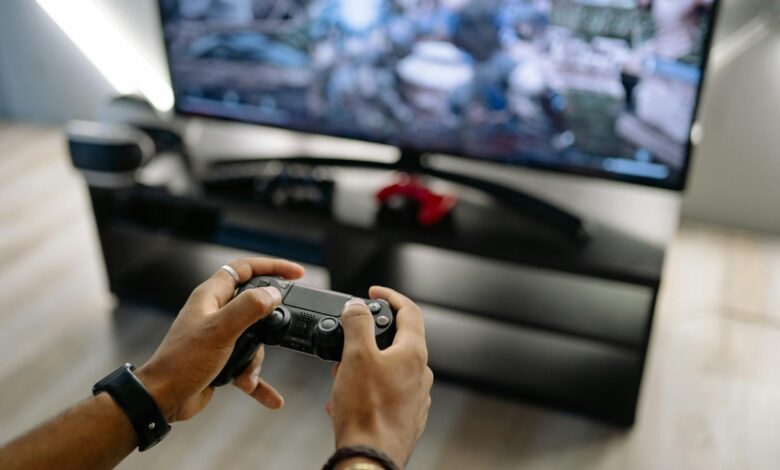 Modern gaming console on entertainment center displaying game selection interface