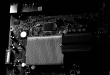 Close-up view of computer graphics card installed on motherboard showing GPU cooling system