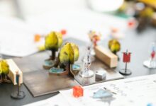 Gaming setup with fantasy RPG elements and dice on wooden table