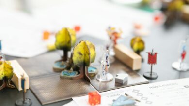 Gaming setup with fantasy RPG elements and dice on wooden table