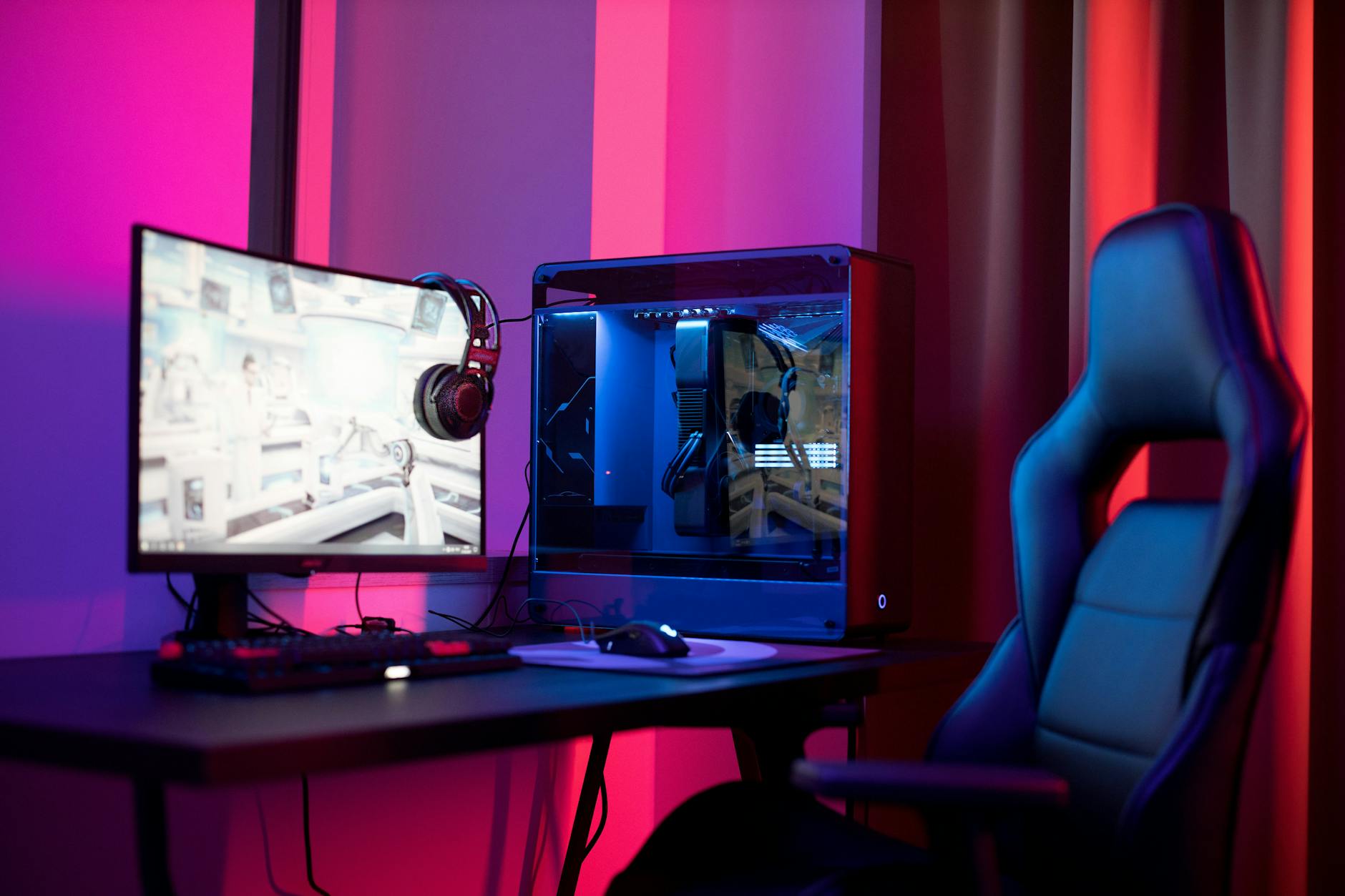 High-performance gaming computer setup with RGB lighting and multiple monitors displaying game content