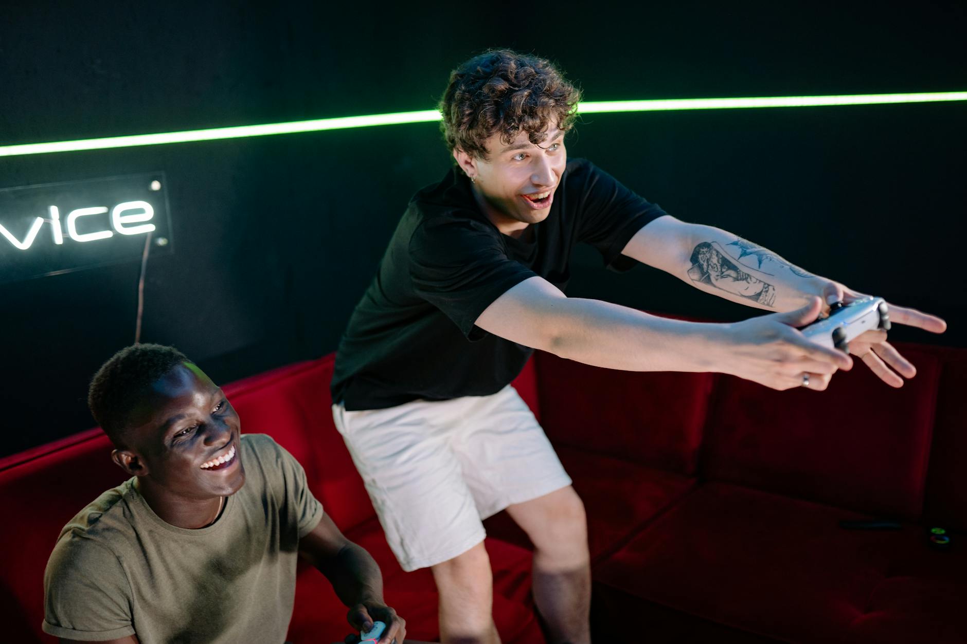 Person holding gaming controller while playing video game on large screen