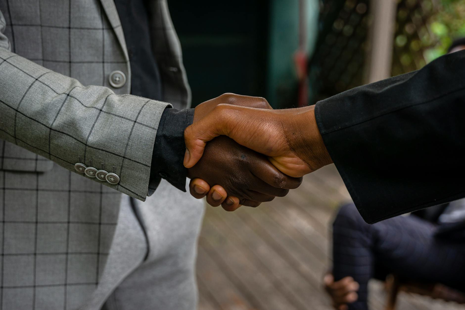 Business handshake symbolizing corporate acquisition and industry consolidation