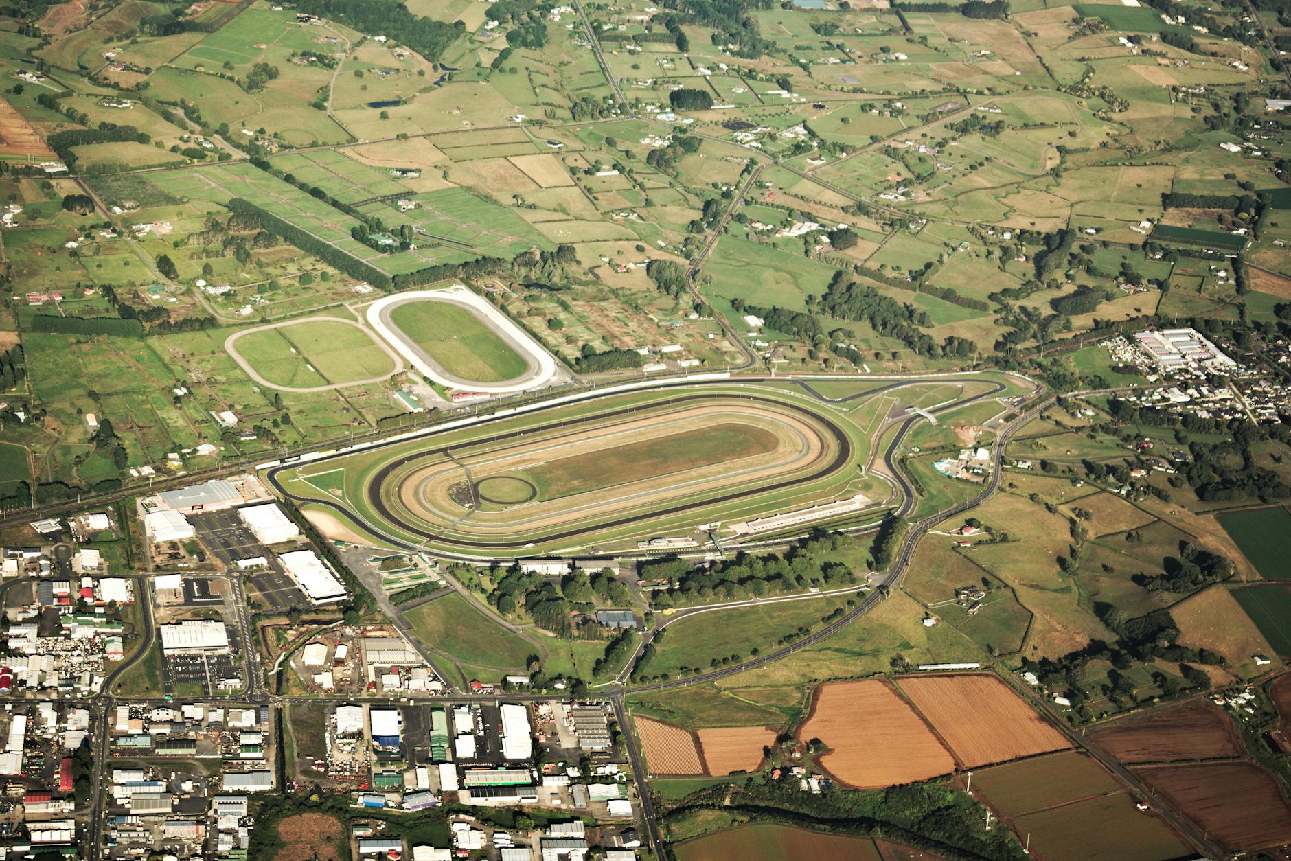 Aerial view of racing track showing curved circuits and racing lines
