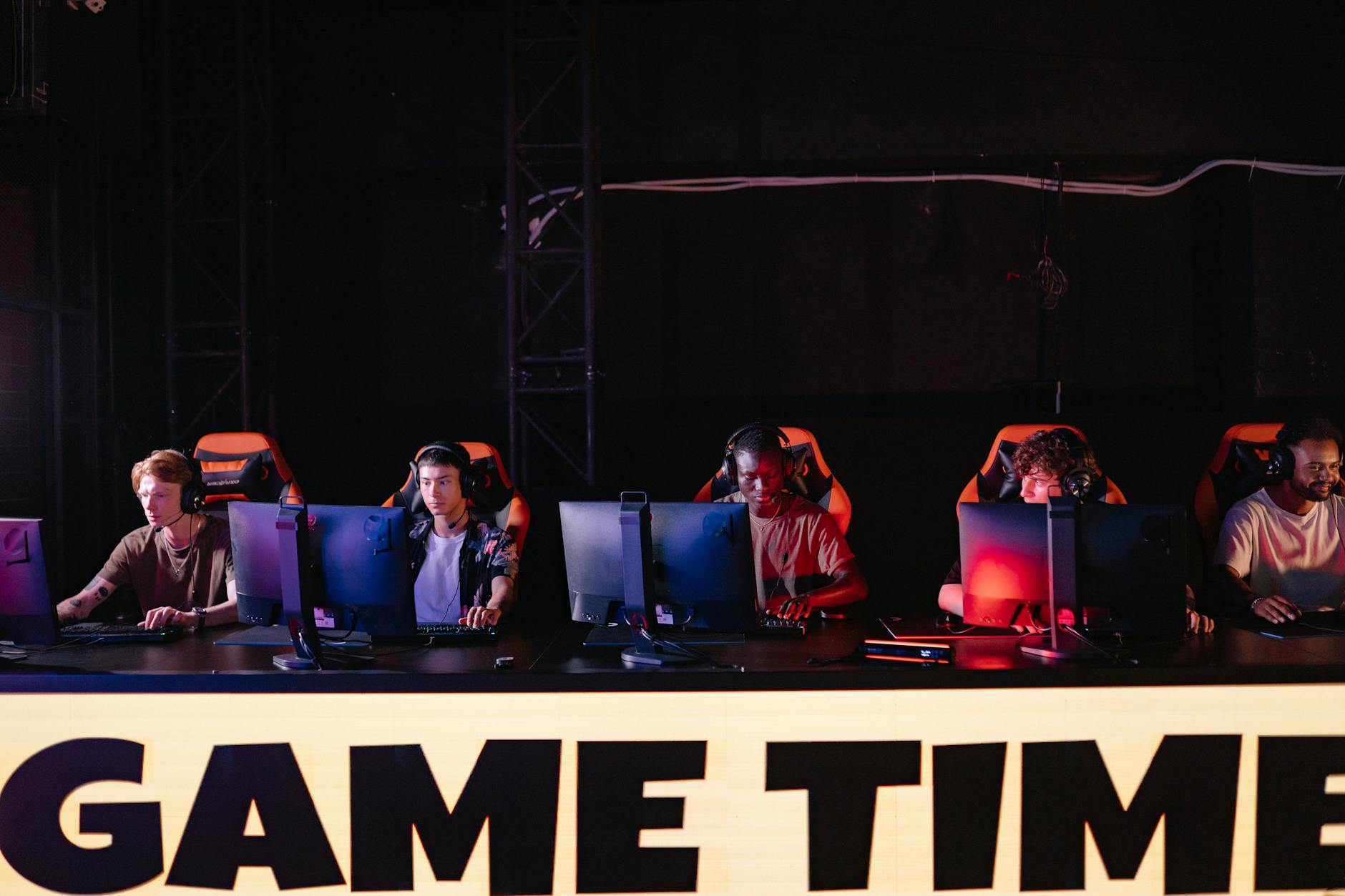 Professional esports tournament stage with large screens and competitive gaming setup