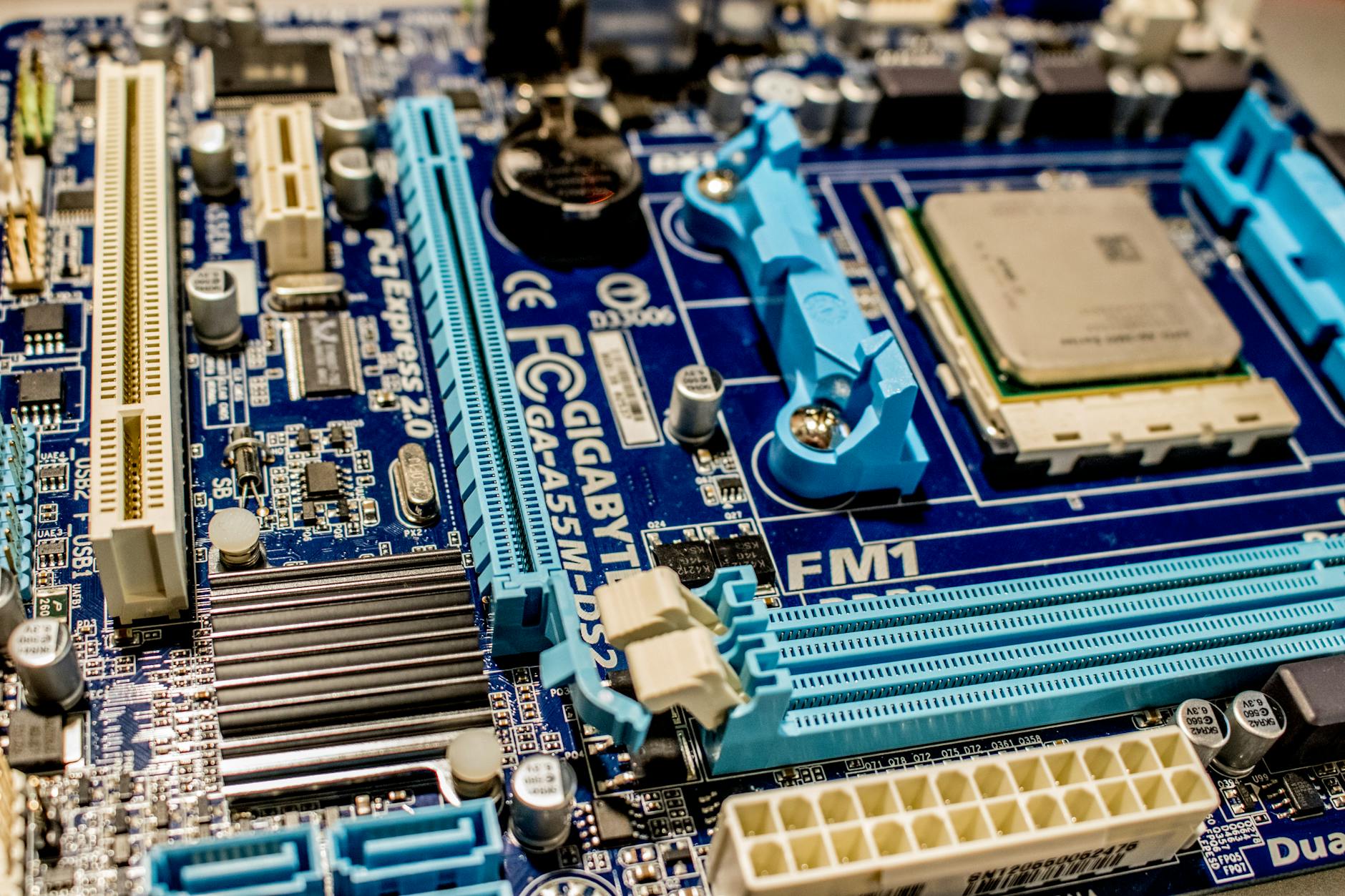 Close-up view of NVMe SSD being installed in modern gaming motherboard