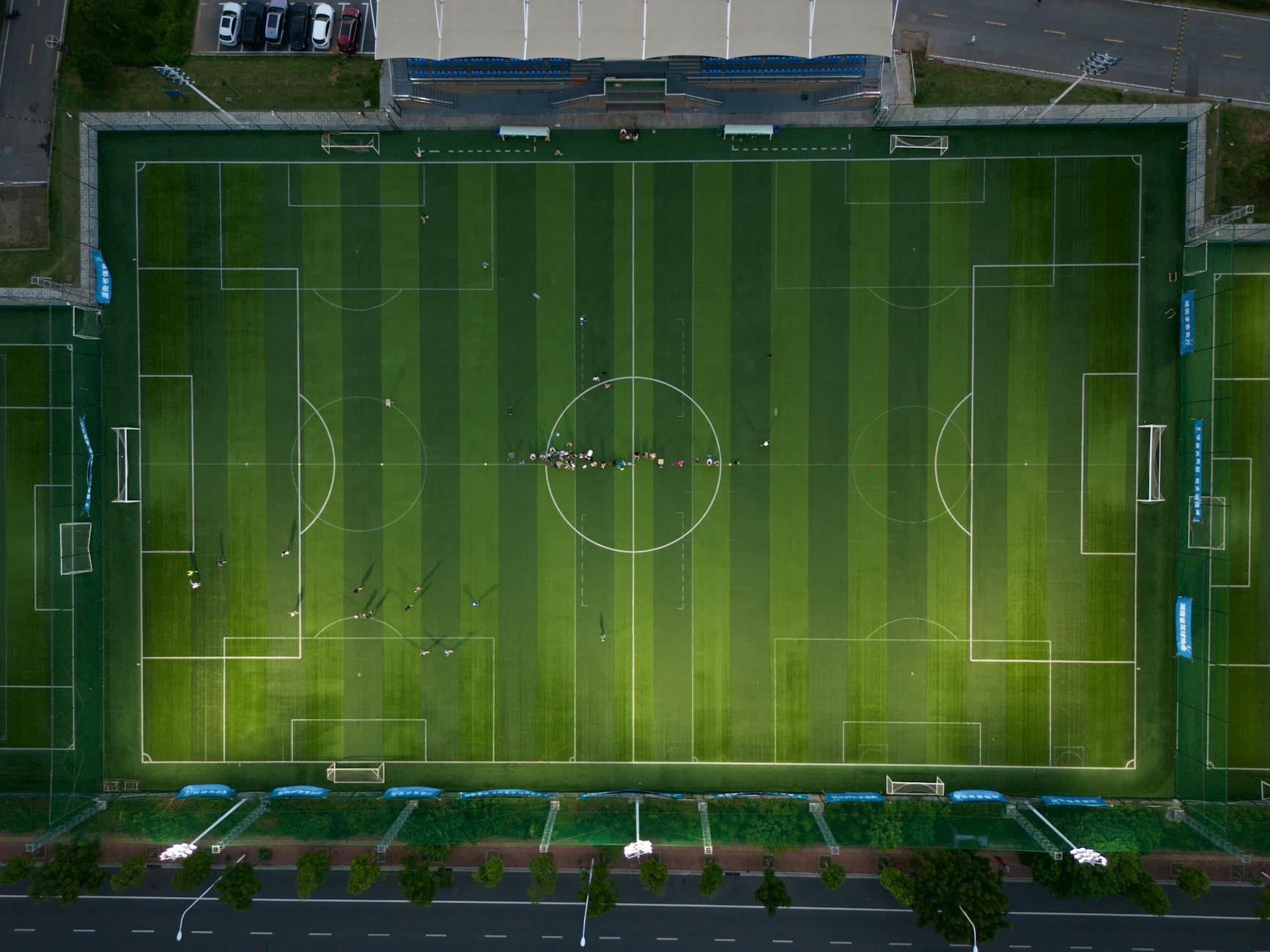 Aerial view of football field with yard lines and goal posts visible