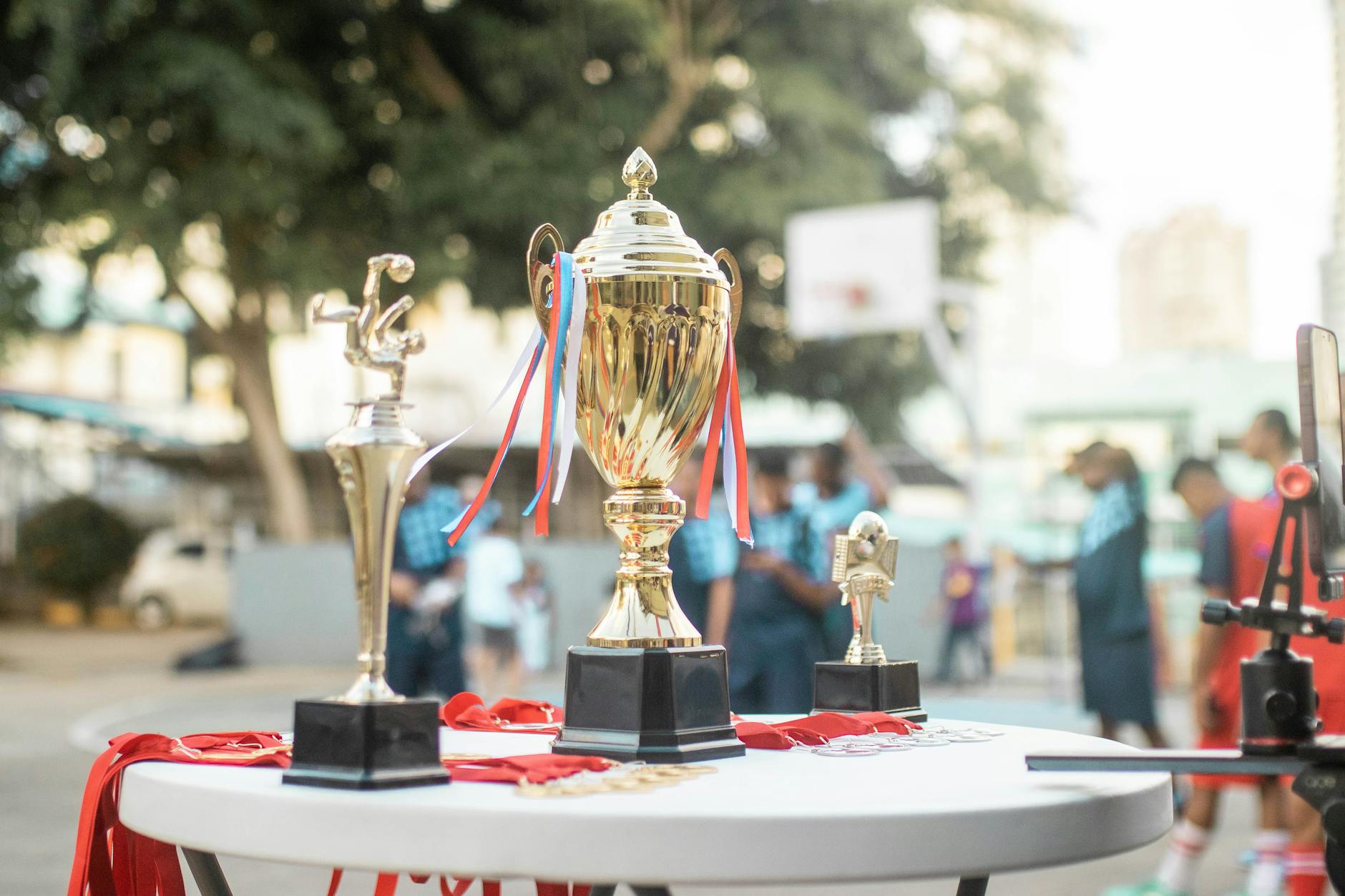 Golden trophy being presented at awards ceremony with spotlights