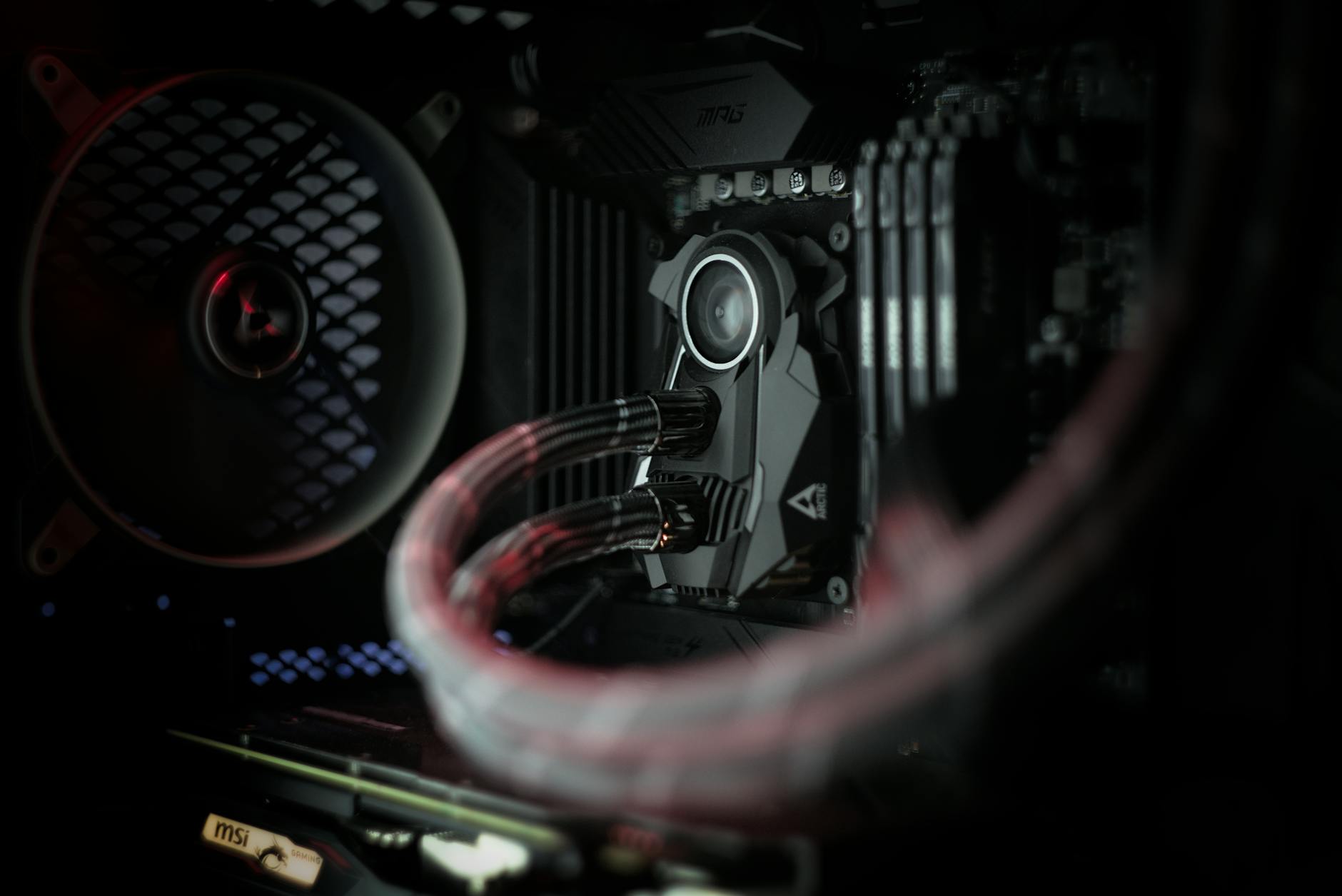 CPU cooler and fans inside a gaming PC case with colorful LED lighting