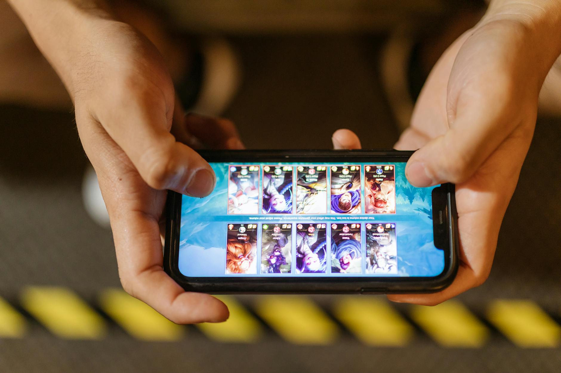 Person playing games on smartphone demonstrating cloud gaming capabilities