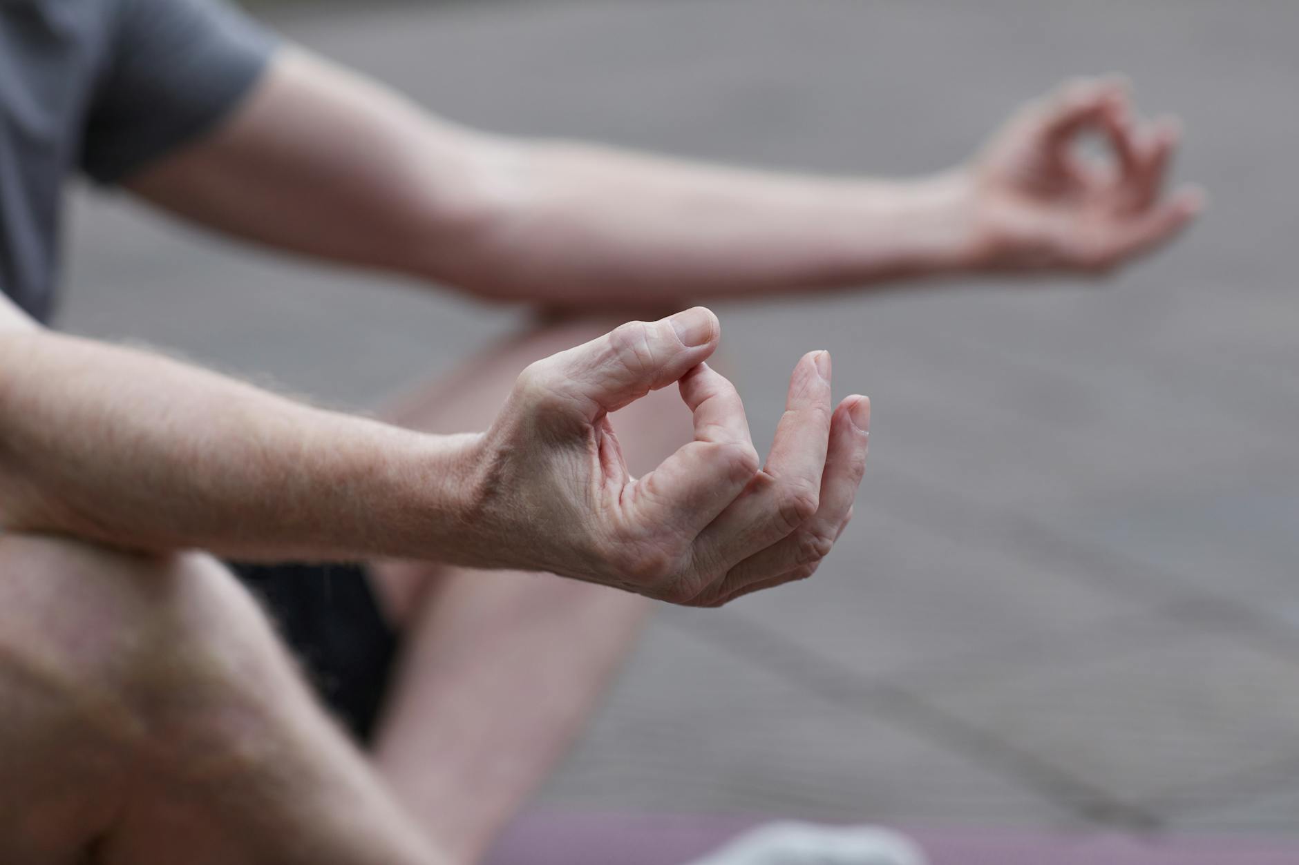 Person meditating in peaceful setting representing mental wellness practices