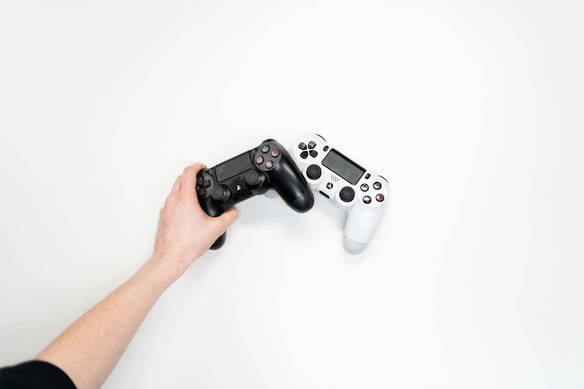Hands holding gaming controller during intense AAA gaming session