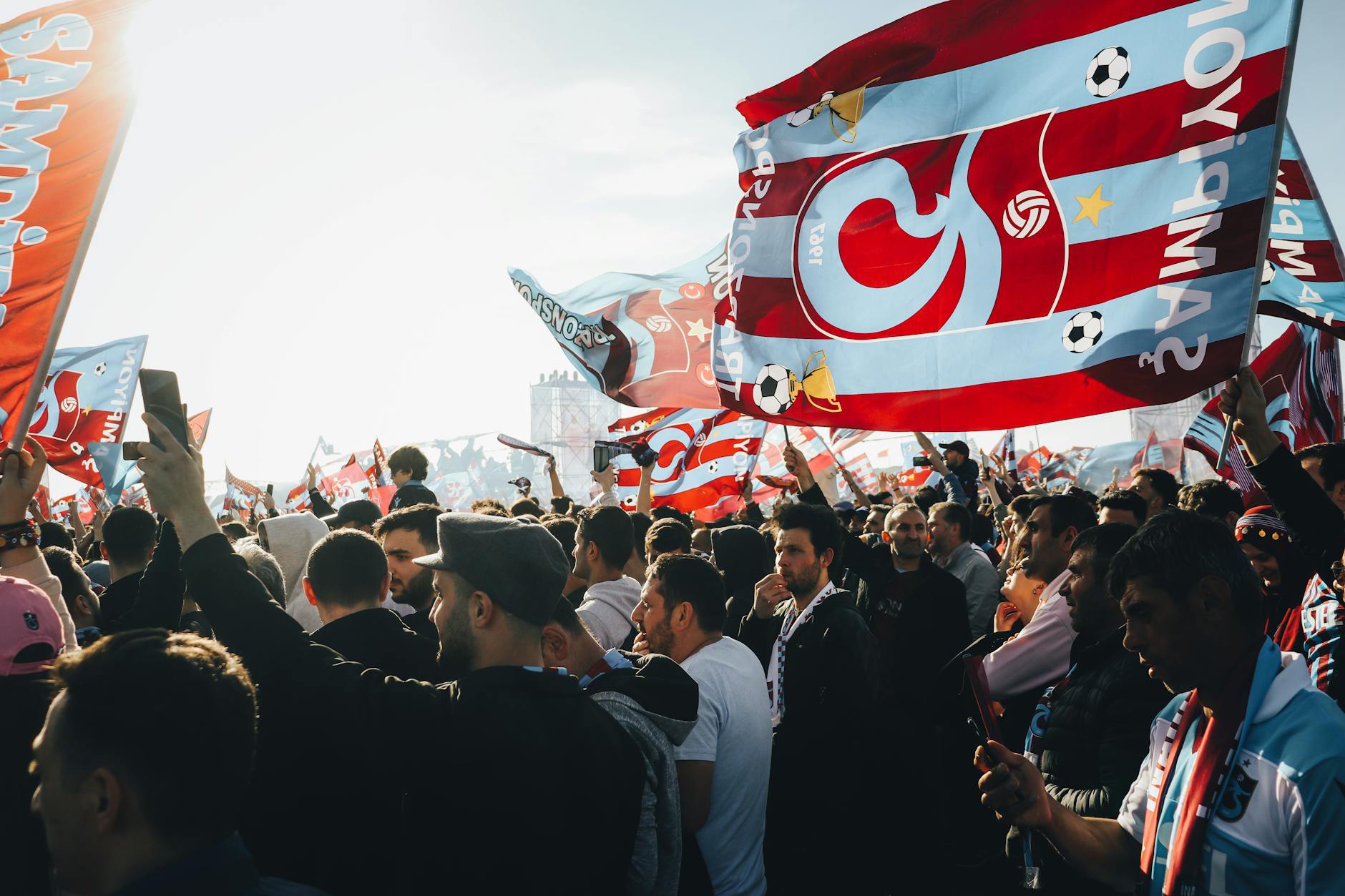 Excited crowd of fans cheering and celebrating at live esports tournament venue