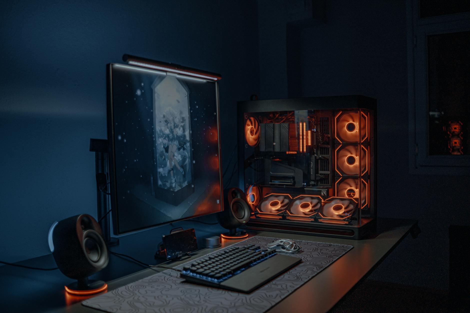 A modern mid-tower PC case with wood front panel sitting on a clean desk setup