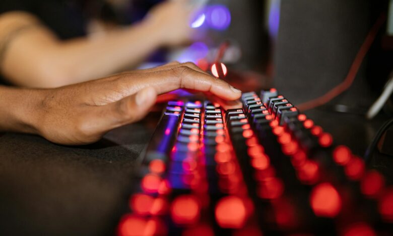 Mechanical gaming keyboard with RGB backlighting on dark desk surface