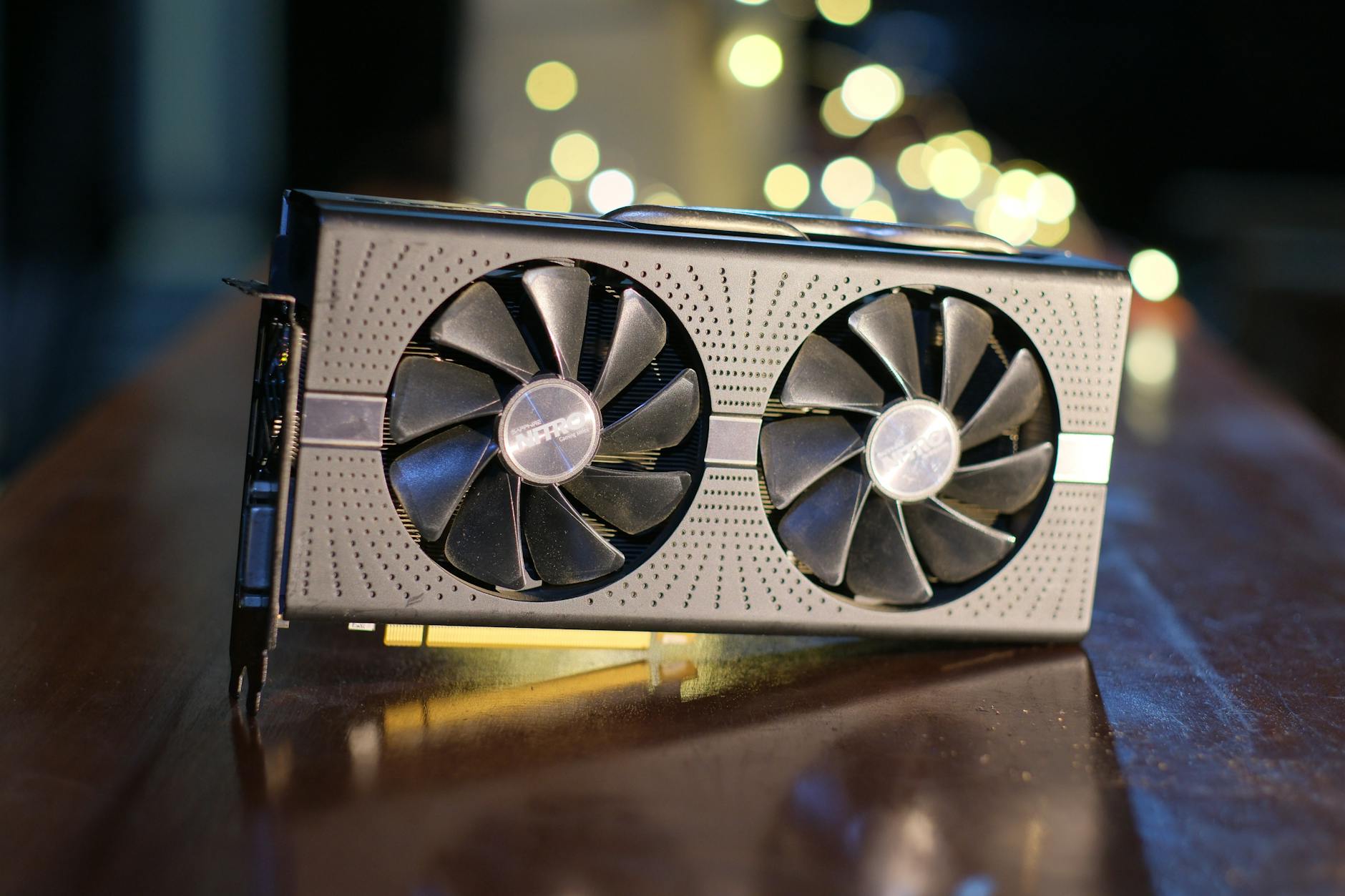 Gaming graphics card being installed into a compact PC case showing clearance and positioning