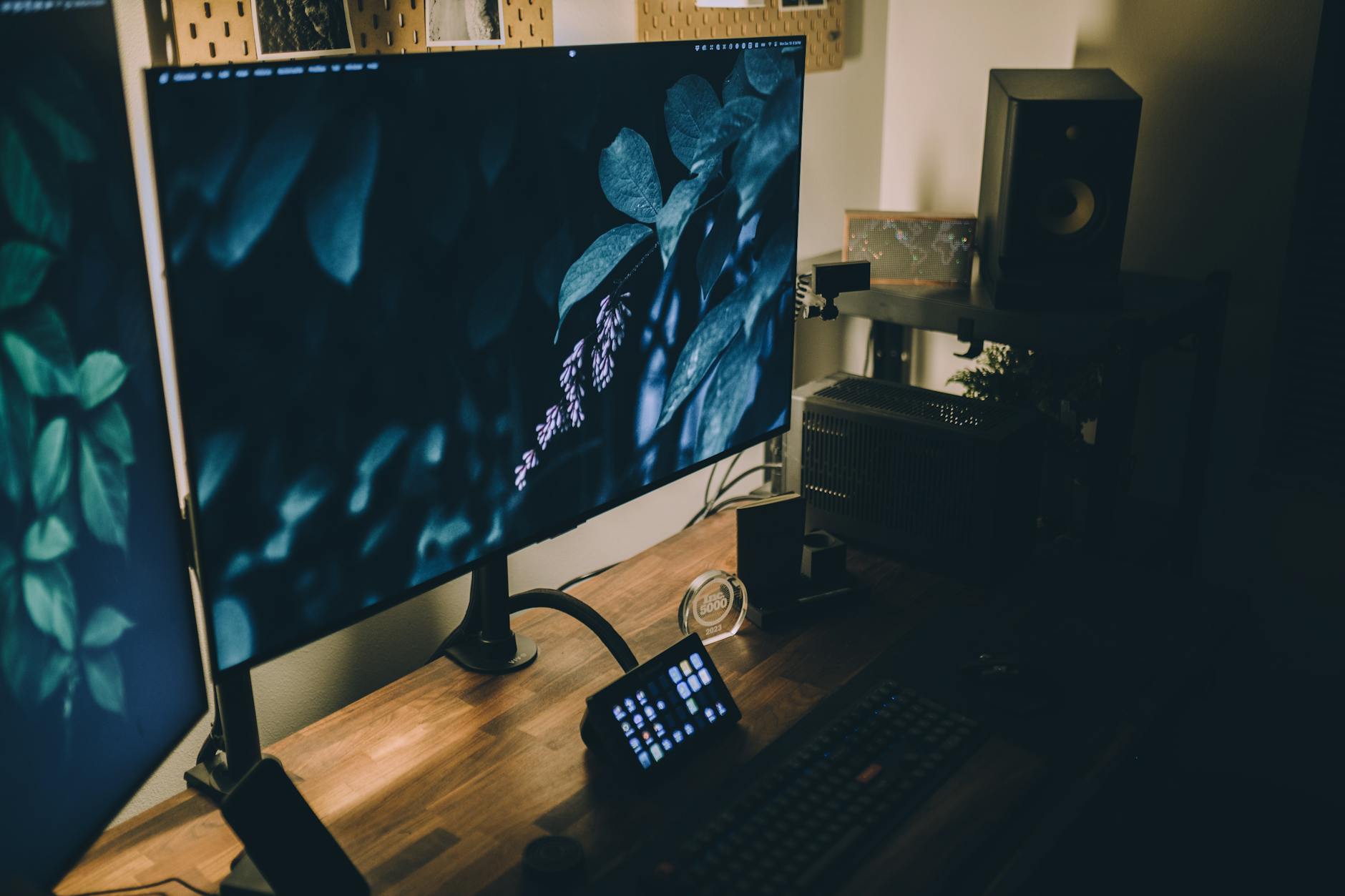 Gaming desk setup featuring a PC case with natural wood finish