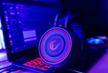 Gaming laptop open on a desk showing performance benchmarks on screen