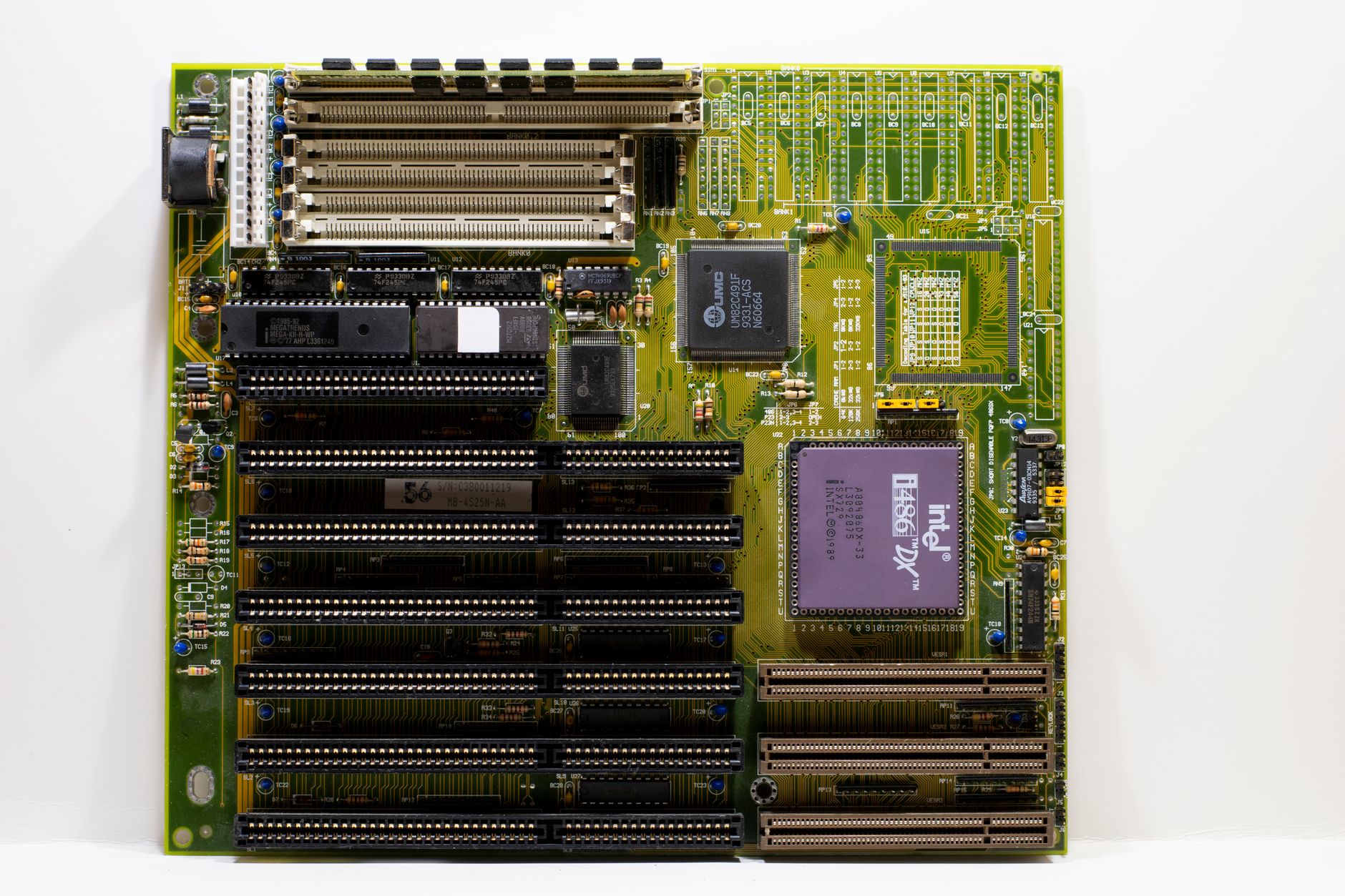 High-end AMD X870E gaming motherboard with VRM heatsinks and RGB lighting visible on a dark surface