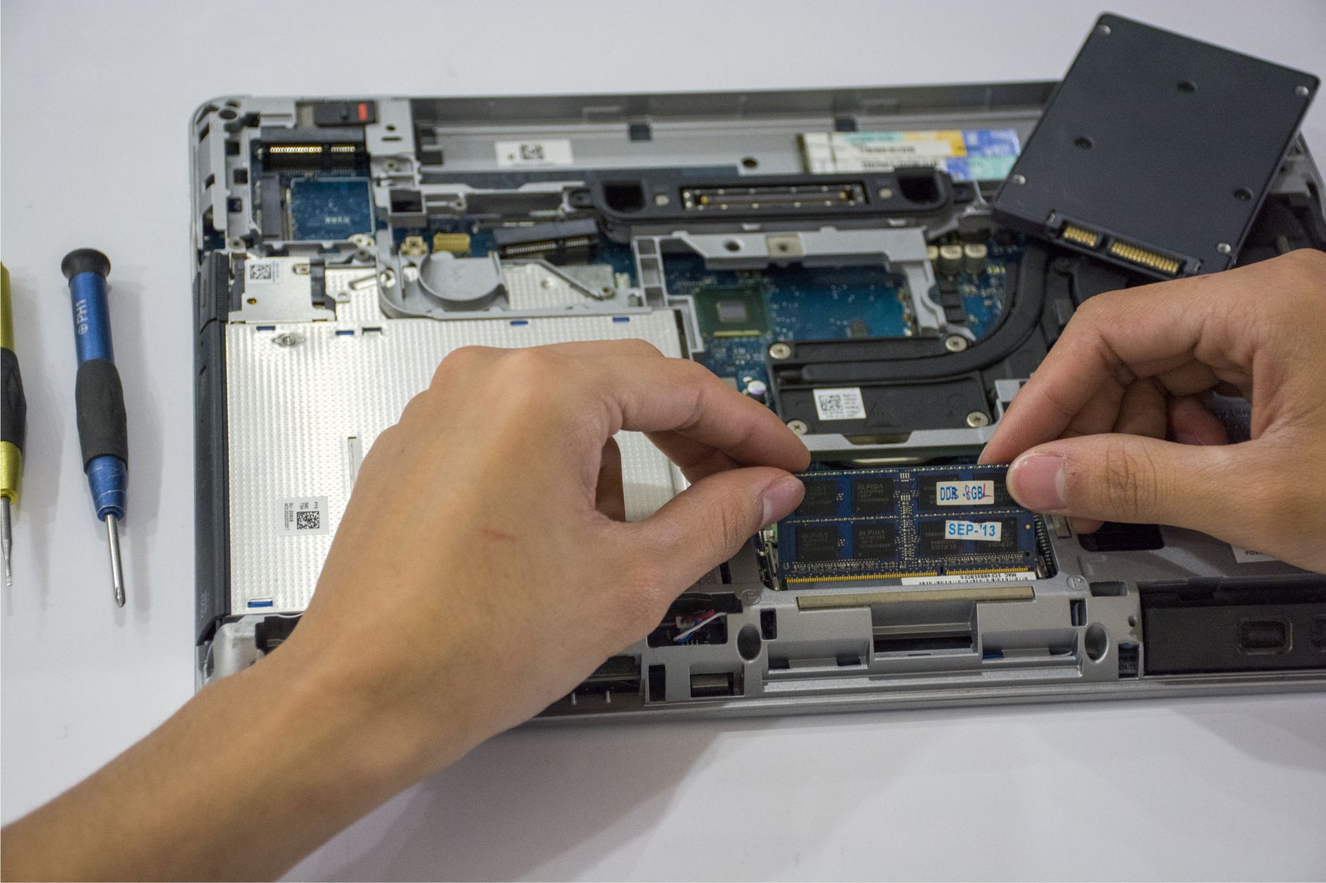 Two NVMe SSDs side by side on a motherboard surface for comparison