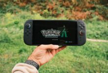 A handheld gaming PC device held in two hands during gameplay